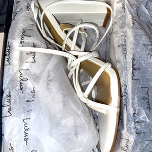 Brand new strapy white chunky open toed heel.